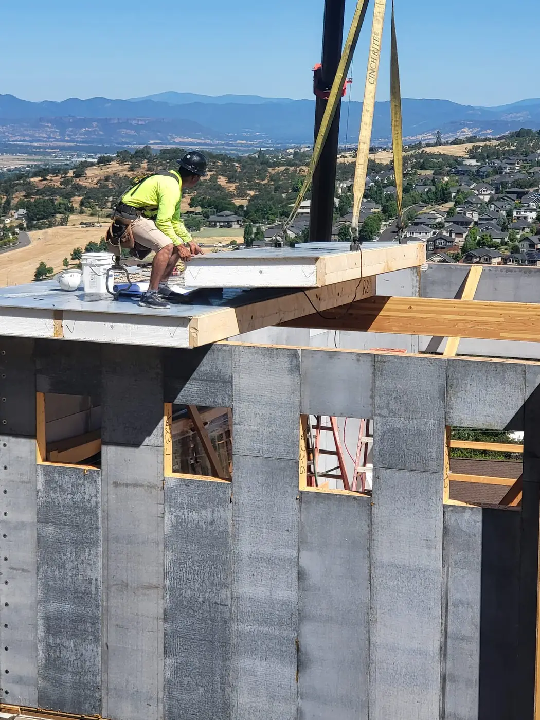 Modular wall panels being set by crane in Medford